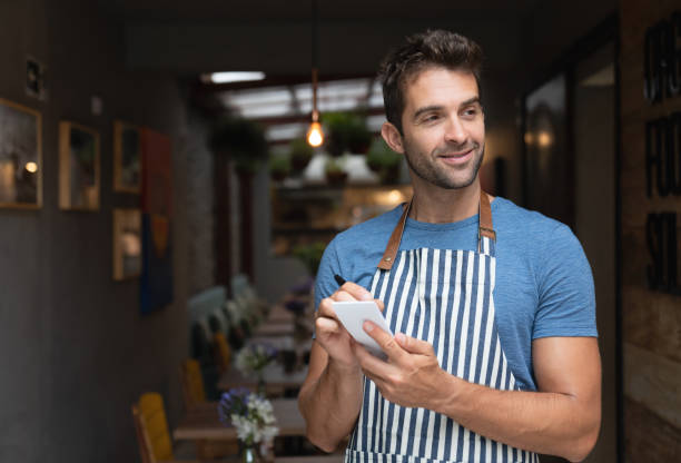 istock Waiter working at a restaurant and writing on a notepad 1143046184