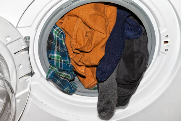 istock An automatic clothes washer with a lot of dirty clothes inside 1143046377