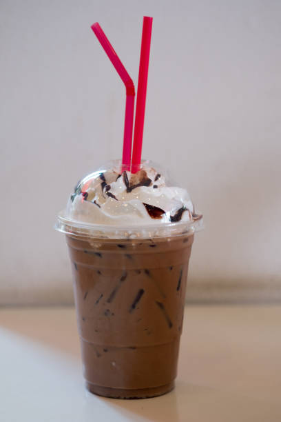 istock Iced cocoa with whipped cream and drinking straw in plastic cup 1143047206