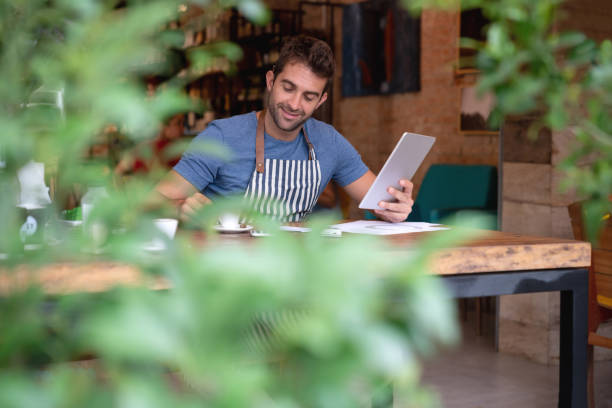 istock Happy business man doing the books at a cafe 1143048268