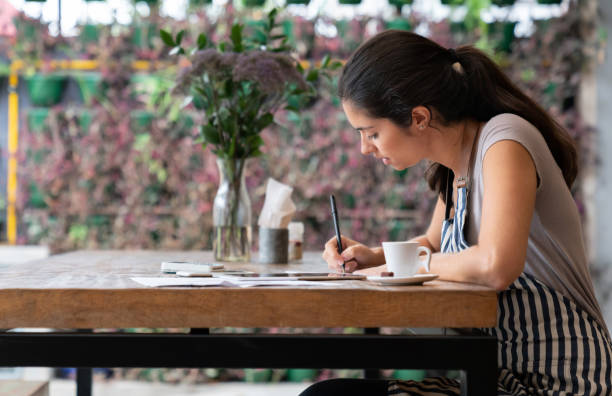 istock Business manager doing the books at a cafe 1143048283