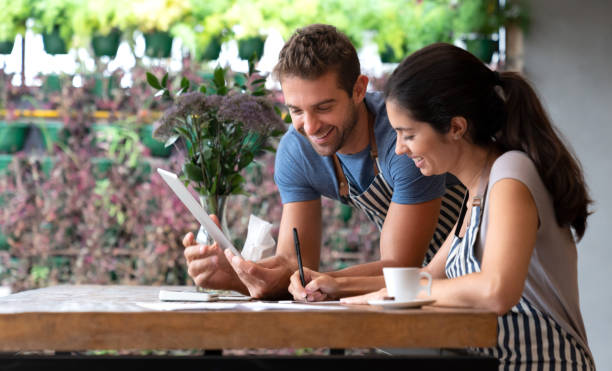 istock Manager doing the books at a restaurant with help of a waiter 1143048290