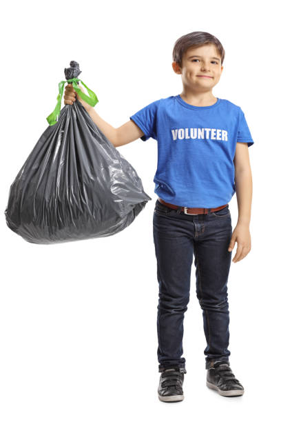 istock Child volunteer holding a waste bag 1143048462