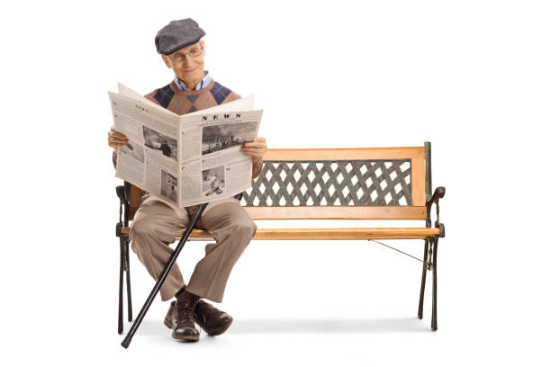 istock Senior man reading a newspaper on a bench 1143048700