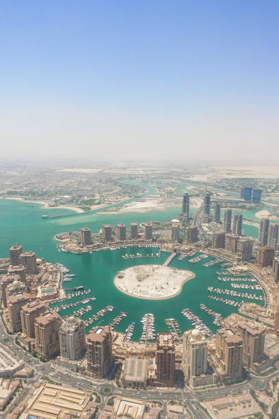 vista del qatar dalla finestra di un aereo con l'ala dell'aereo. vista del porto turistico della baia di corniche della città di doha - east middle road desert foto e immagini stock