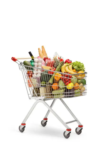 Shopping cart full of food products isolated on white background