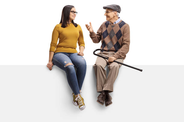 istock Senior man sitting on a panel and talking to a young girl 1143050731