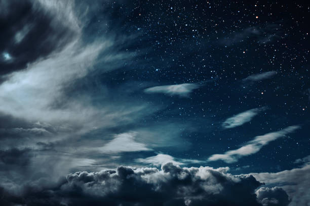 istock backgrounds night sky with stars and moon and clouds. 1143052252