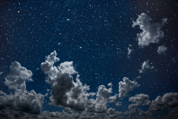 istock backgrounds night sky with stars and moon and clouds. 1143052261