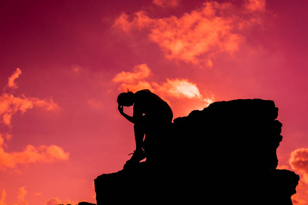 silhouette women sitting alone on the rock. mental health, ptsd and suicide prevention. - solicitous imagens e fotografias de stock