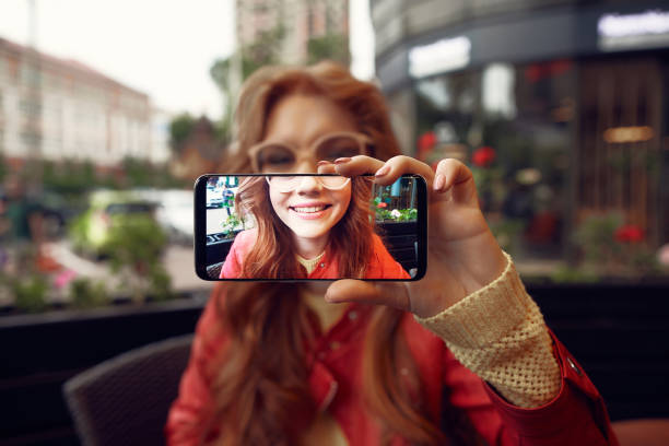 istock Charming young lady making selfie and smiling 1143052818