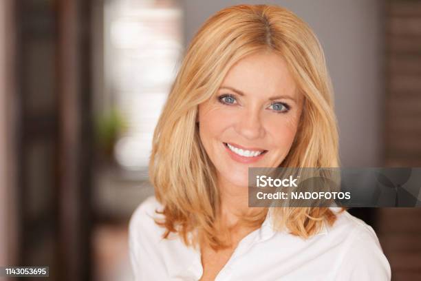 Mature Woman Smiling At The Camera She Relaxing At Home Beautiful Stock Photo - Download Image Now