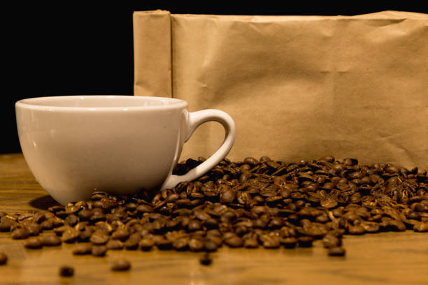 istock A bag of coffee beans with a coffee cup on a wooden table. 1143054049