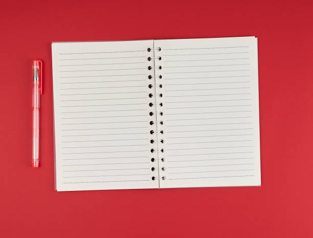 istock open notebook in line and gel pen on a red background 1143054504