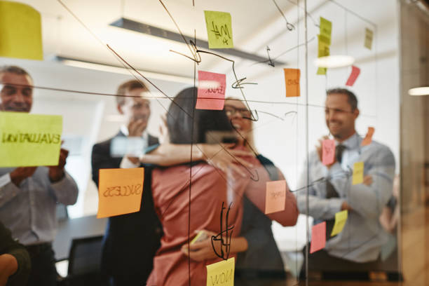 istock Two businesswomen hugging during an office brainstorming session 1143054510