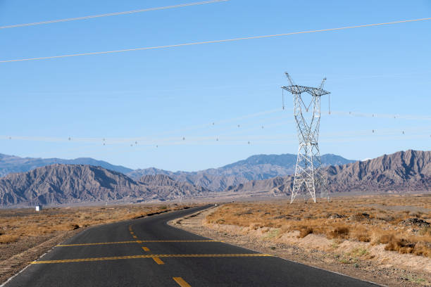 istock Highway and high voltage pylons against a blue sky background 1143057468