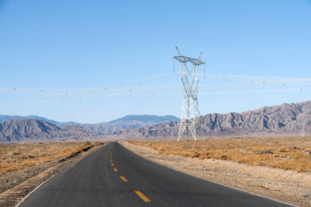 istock Highway and high voltage pylons against a blue sky background 1143057478
