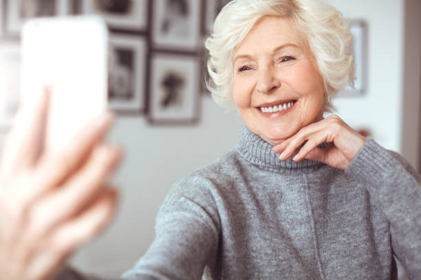 istock Wrinkles but clear face. Selfie time. Handsome grandma 1143058042