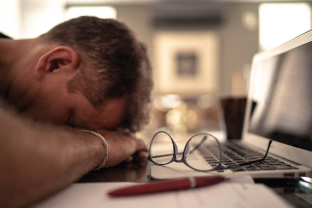 istock Tired man taking a nap during home office 1143058900