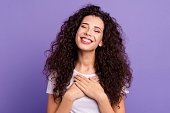 Close up photo beautiful amazing her she lady eyes closed hold both arms hands on chest very pleased sweet emotions feelings wear casual white t-shirt clothes outfit isolated violet purple background