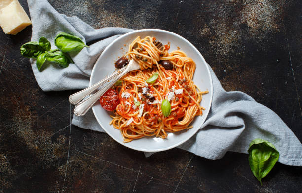 istock Spaghetti with tomato sauce olives and capers 1143064548