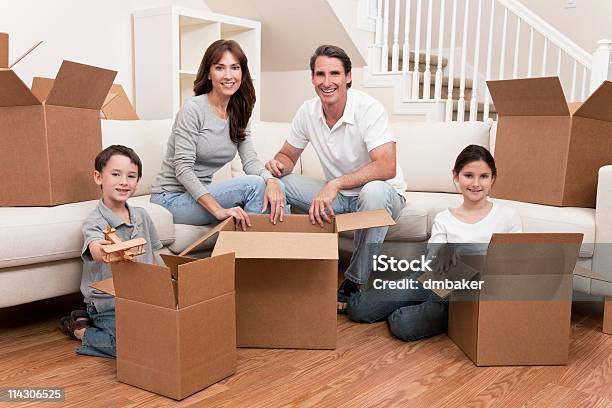 Family Unpacking Or Packing Boxes Moving House Stock Photo - Download Image Now - Adult, Box - Container, Cardboard Box