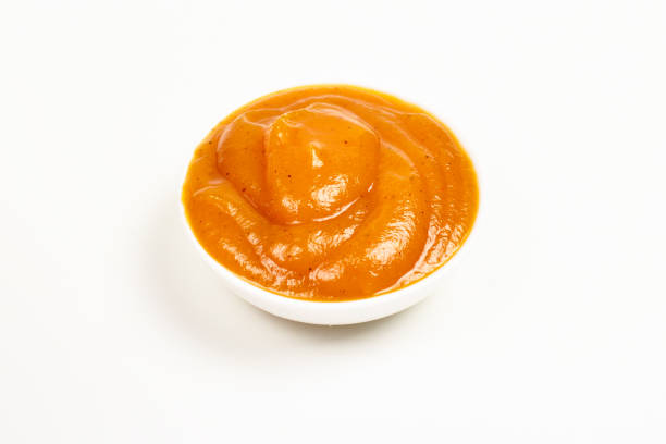 istock Orange sauce in white plate on white background. 1143065941