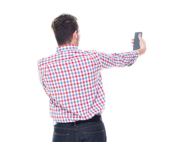 istock Attractive young man wearing a checked shirt and jeans - taking a selfie 1143069040