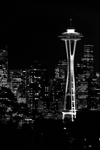 black and white image of the lights of the seattle skyscrapers at night. - seattle night skyline architecture and buildings imagens e fotografias de stock