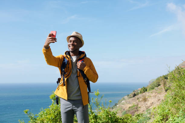 istock smiling african american hiker taking selfie in nature 1143072523