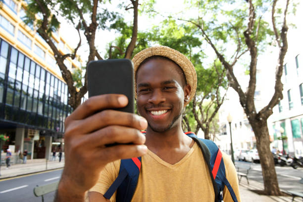 istock smiling young african american man taking selfie 1143072579