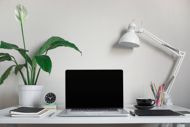 istock Modern work table with blank computer laptop and accessories in home office studio.Freelance designer or blogger concepts ideas 1143072744