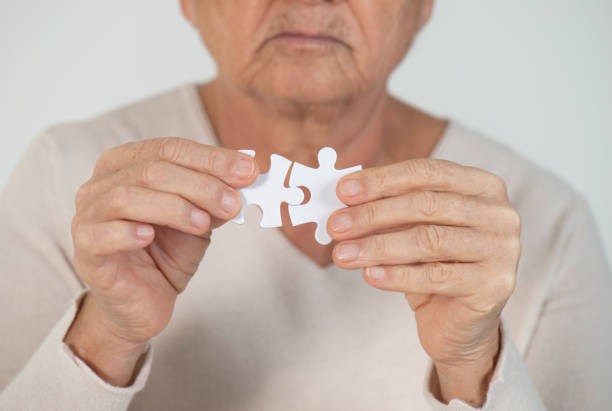 istock Elderly woman with puzzle 1143073926