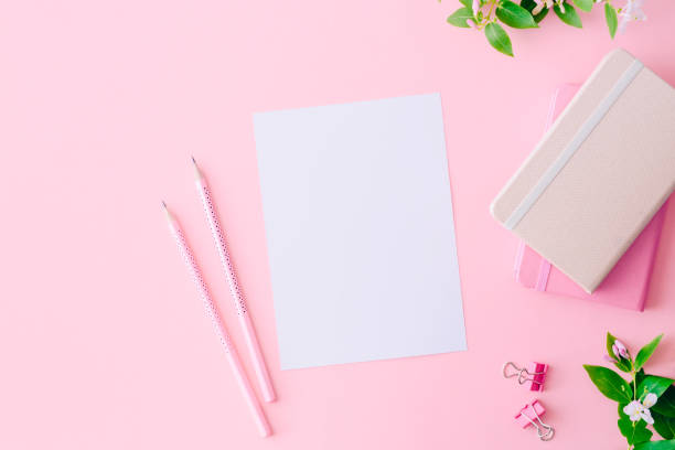 istock Mockup white greeting card with branches and green leaves on a pink background 1143074109