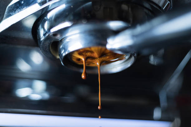 Coffee extraction from a espresso machine. Close-up