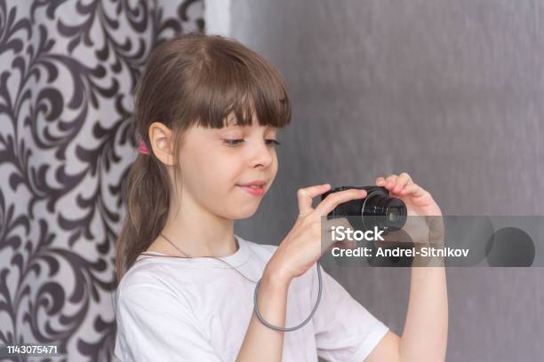 Girl Photographs With A Camera Stock Photo - Download Image Now - Beautiful People, Child, Cute