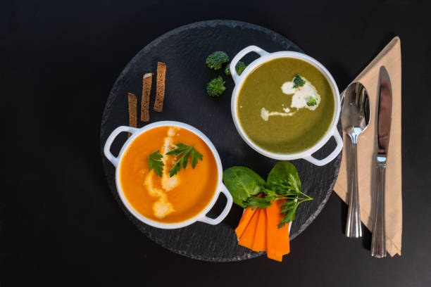 delicious healthy broccoli and butternut soups - portion pumpkin vegetable black imagens e fotografias de stock