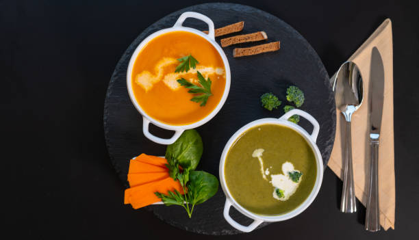 bowls of healthy pumpkin and butternut soups - portion pumpkin vegetable black imagens e fotografias de stock