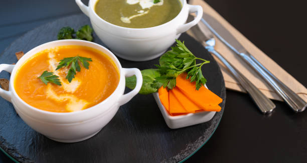 bowls of tasty gourmet fresh vegetable soup - portion pumpkin vegetable black imagens e fotografias de stock