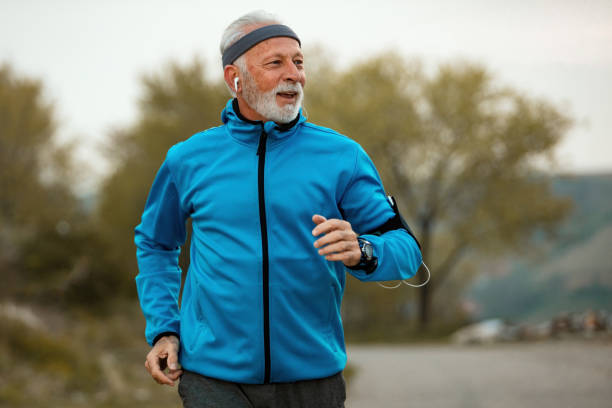 istock Happy senior man jogging in nature. 1143077951