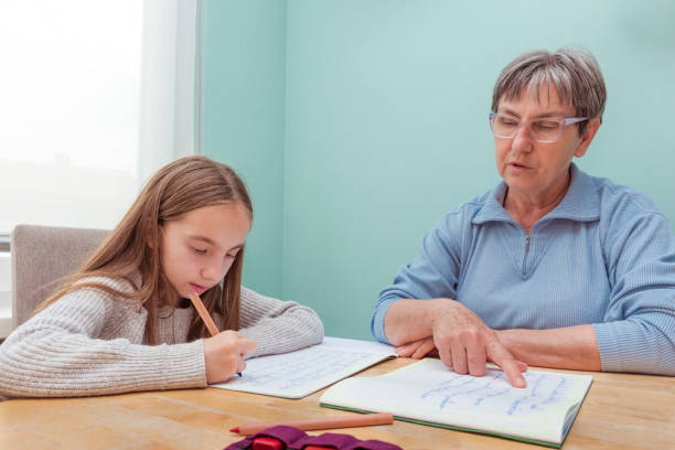 istock Grandmother Helping Granddaughter Doing Homework 1143078812