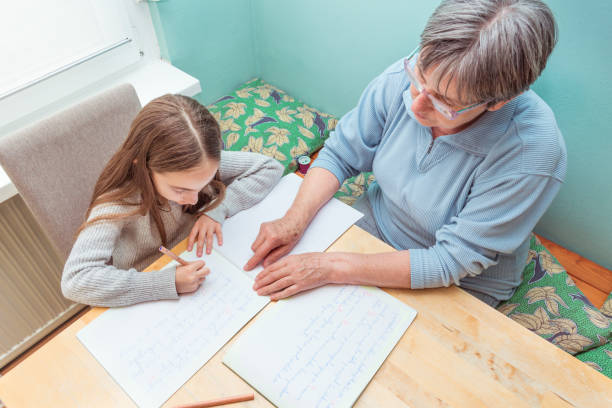 istock Grandmother Helping Granddaughter Doing Homework 1143078814