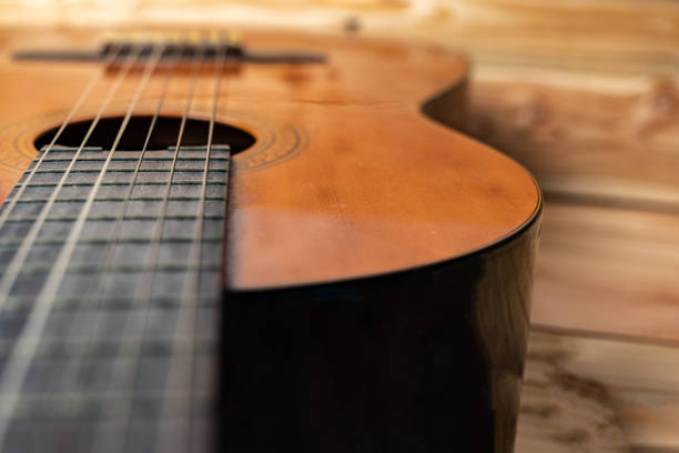istock Old classical guitar on wooden background 1143079625