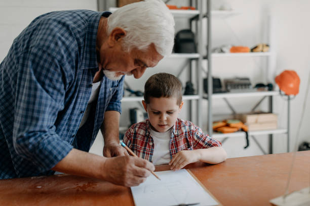 istock Grandfather and grandson building a ship 1143079989