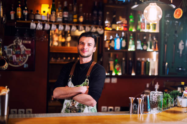 istock Portrait of happy bartender at bar counter. 1143080924
