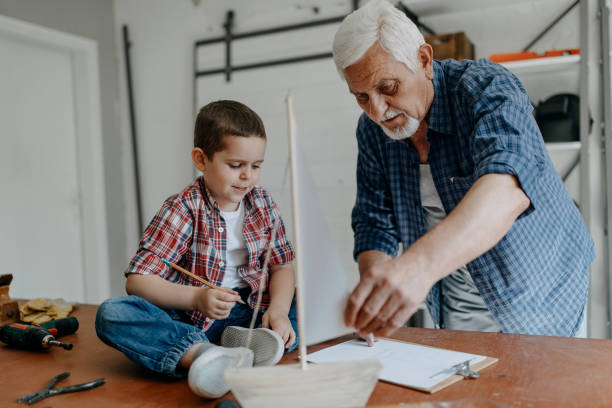 istock Grandfather and grandson building a ship 1143080985