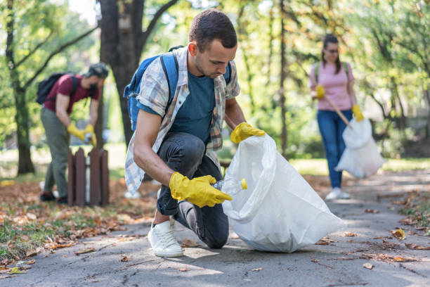 istock Young volunteers cleaning the local park from plastic bottles 1143081130
