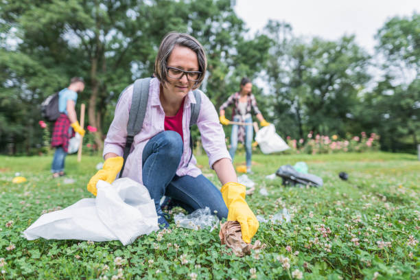istock Woman picking up garbage in the park 1143081159