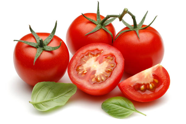 istock Fresh tomatoes and basil leaves isolated on white 1143082721