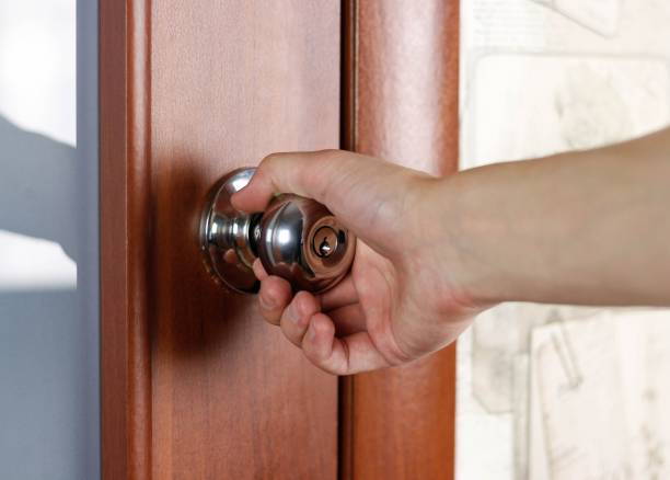 istock Hand opens the door by the handle. Close up 1143083242